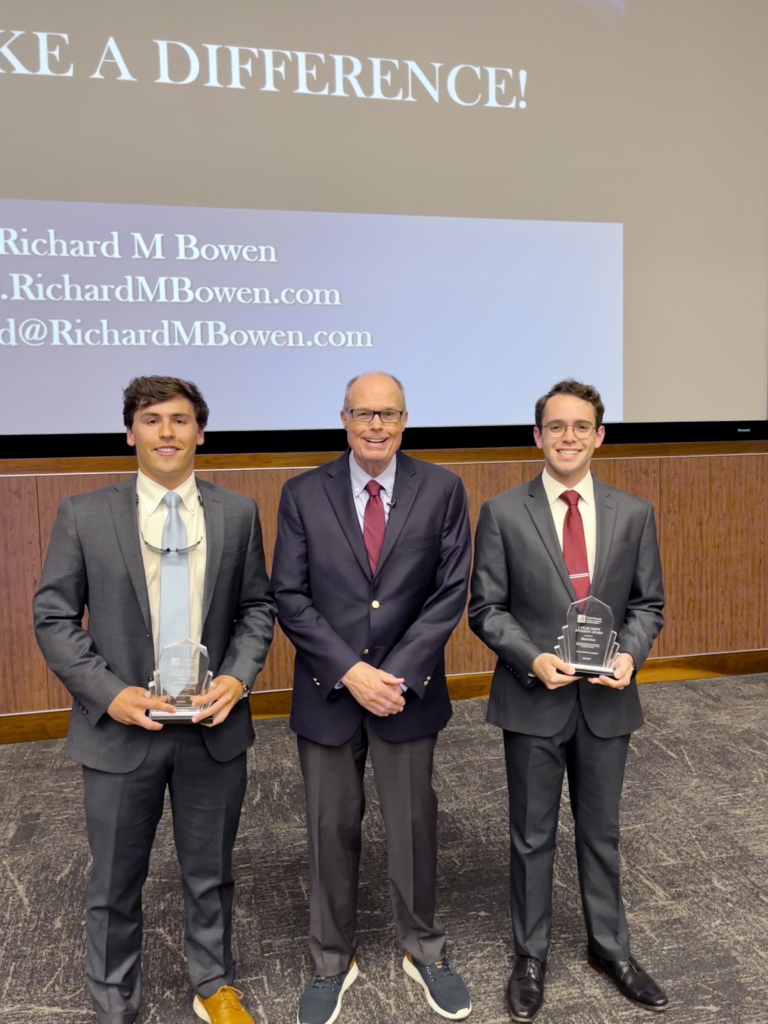 Richard M. Bowen stands with Micah Hodes and Sam Guerrero, who won the J. Craig Smith Integrity Award.