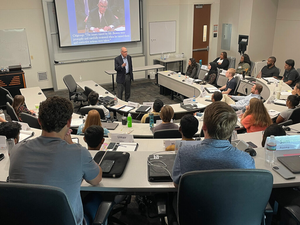 Image: Richard M. Bowen speaking to a room full of MBA students at UTD.