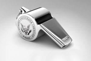 Photo of a silver whistle with the SEC's logo on the side.