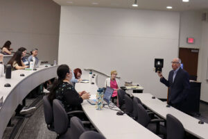 Photo of Richard M. Bowen speaking to students in a classroom.