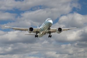 Image: Plane taking off under cumulus clouds