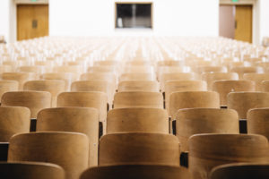 Image of empty wooden seats in a theater or classroom