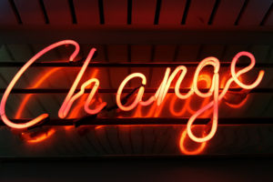 Image of orange neon sign that says "Change"